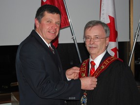 Central Elgin Deputy Mayor David Marr, right, was acclaimed warden of Elgin county for 2014 at a ceremony in council chambers on Tuesday evening. Here, he stands with 2013 Warden Cameron McWilliam, who is adjusting the chain of office.
