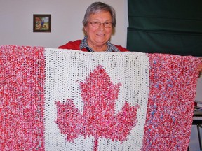 Shirley Kleine Deters shows off her 'pride and joy,' a small blanket made entirely out of Beatrice milk bags. The Sarnia woman has made more than seven dozen blankets to be sent to impoverished regions of the world to help combat infections. HEATHER BROUWER/ SARNIA THIS WEEK/ QMI AGENCY