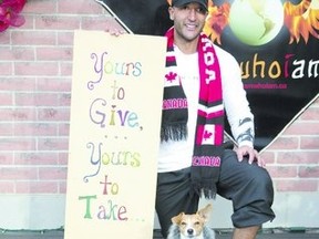 Heykel Kader put a sign and two plastic bins outside his business on Wortley Rd. During the day, the bins fill with donated goods and at night the goods disappear, he said. (DEREK RUTTAN, The London Free Press)