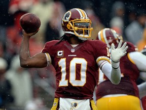 Quarterback Robert Griffin III of the Washington Redskins throws a pass in the first half during an NFL game against the Kansas City Chiefs at FedExField on December 8, 2013 in Landover, Maryland. (Patrick McDermott/Getty Images/AFP)