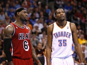 Miami Heat forward LeBron James (L) talks to Oklahoma City Thunder's forward Kevin Durant during a free throw attempt by a Thunder player in the second half of their NBA basketball game in Oklahoma City, Oklahoma February 14, 2013. (REUTERS)