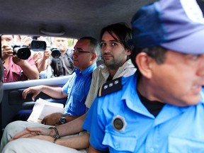 Eric Justin Toth of the U.S. sits in a police car after a presentation to the media at the police headquarters building in Managua on April 22, 2013. (REUTERS/Oswaldo Rivas)