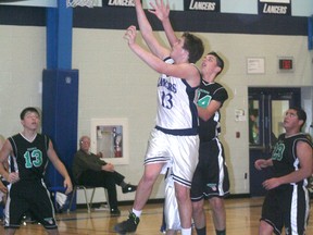 Trenton McGrail of the Ursuline Lancers goes up for a layup against the Herman Green Griffins of Windsor Dec. 6 at the Pines. Herman won the Shoe Place junior tournament opening game 40-30.