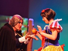 Aaron Bell photo
The “Evil Queen”  Andrew McGillivray offers and apple to Snow White, played by  Gabi Epstein, in the Moonpath Productions' version of Snow White, a holiday panto now playing in two versions – family and naughty – at the Empire.