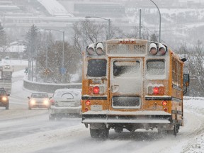 Vehicles makes their way down Scona Road in Edmonton, Alta., on Thursday, Dec. 12, 2013. The city experienced 5-10 centimetres of snow on Thursday, leading to slippery streets and sidewalks. Ian Kucerak/Edmonton Sun/QMI Agency