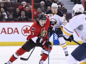Ottawa Senators' Kyle Turris carries the puck in between Buffalo Sabres' Zemgus Girgensons and Brian Flynn during NHL hockey action at the Canadian Tire Centre in Ottawa on Thursday December 12,2013. Errol McGihon/Ottawa Sun/QMI Agency