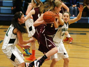 The Panthers Madison Whiting reaches out to put the brakes on a drive to the hoop by an Okotoks player during the Grove school’s opening game at the 2013 Ross Sheppard Totem Hoop tournament. - Gord Montgomery, Reporter/Examiner