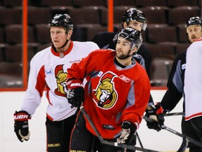 Ottawa Senators' Chris Neil (L) and Corey Conacher showed some intensity in practice, as evidenced by Conachers broken stick-courtesy Neil- at the Canadian Tire Centre on Friday December 13,2013. 
Errol McGihon/Ottawa Sun/QMI Agency