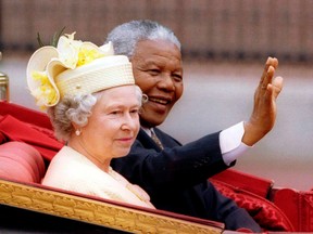 South Africa's President Nelson Mandela and Britain's Queen Elizabeth ride in a carriage outside Buckingham Palace on the first day of a state visit to Britain, in this July 9, 1996 file photo. Mandela passed away on Dec. 5, 2013 at the age of 95.  REUTERS/QMI Agency