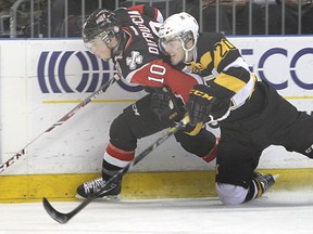 Kingston's Roland McKeown and Niagara IceDogs' Anthony DiFruscia collide against the boards during the first period in Friday night's OHL game at the Rogers K-Rock Centre. (Michael Lea/The Whig-Standard)