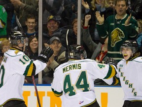 London Knights Christian Dvorak and Dakota Mermis congratulate Mitchell Marner after he scored with 5.4 seconds left in the first period of their Ontario Hockey League game against the Guelph Storm at Budweiser Gardens on Friday night. London won 5-2. (MIKE HENSEN, The London Free Press)