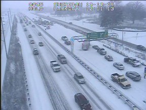 Traffic slows on the westbound QEW after an accident during winter weather in 2013. (COMPASS cameras)