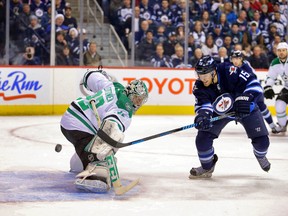 Winnipeg Jets forward Matt Halischuk (15) scores on Dallas Stars goalie Kari Lehtonen (32) during the first period at MTS Centre. (Bruce Fedyck/USA TODAY)