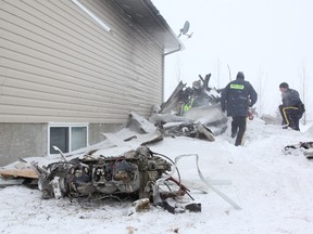 Parts of a light plane are seen near a house north of Lloydminster Saturday. The pilot was killed when the plane crashed on a field and skidded up to the house. (DON WHITING/Special to QMI Agency)