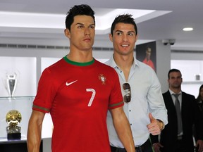 Cristiano Ronaldo poses with his statue during the inauguration of his museum in Funchal, Portugal on Sunday, Dec. 15, 2013. (Duarte Sa/Reuters)
