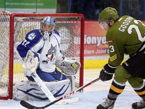 Sudbury Wolves goalie Franky Palazzese defelects a shot from North Bay Battalion Barclay Goodrow,  during OHL action from the Sudbury Community Arena on Sunday December 15/2013.
Gino Donato/The Sudbury Star/QMI Agency