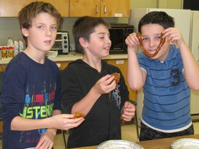 Ecole St-Antoine students enjoy pulling taffy during the feast of Ste. Catherine celebration in Noelville. Photo supplied