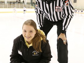 Referee Eric Caetano and his helper Meghan McInnes show off their donation bucket at the McClelland Arena in Copper Cliff on Sunday night. Caetano has spearheaded a campaign to raise funds for children's care at Health Sciences North.  Gino Donato/The Sudbury Star