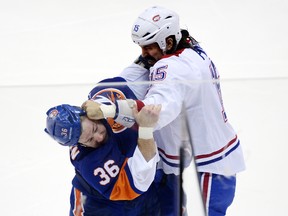Canadiens winged George Parros (15) and Islanders winged Eric Boulton (36) fight during the first period at Nassau Veterans Memorial Coliseum, Dec. 14, 2013. (Joe Camporeale-USA TODAY Sports)