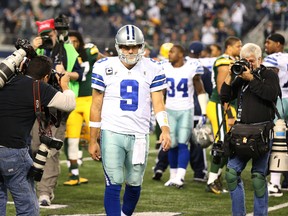 Cowboys quarterback Tony Romo (9) walks off the field after the game against the Green Bay Packers at AT&T Stadium in Arlington, Tex., Sunday, Dec. 15, 2013. (Matthew Emmons-USA TODAY Sports)