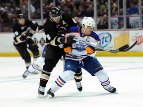 Oilers captain Andrew Ference keeps Teemu Selanne at bay last night in Anaheim (Kelvin Kuo, USA Today).