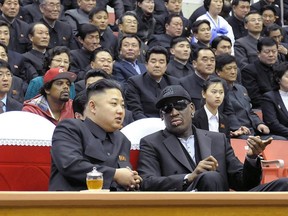 This photo taken on February 28, 2013 and released by North Korea's official Korean Central News Agency shows North Korean leader Kim Jong-Un (front L) and former NBA star Dennis Rodman (front R) speaking at a basketball game in Pyongyang. (AFP PHOTO / KCNA)
