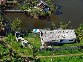Some Filipinos wrote this on the roof of their house in Roxas City, located in the extreme north of Panay Island in the Philippines, as a thank you note to the Canadian Forces for their contribution in the typhoon-ravaged country during 'Operation Renaissance 13-1'. This photo was taken Dec. 12. — Photo by: Mast. Cpl. Marc-André Gaudreault/Combat Camera