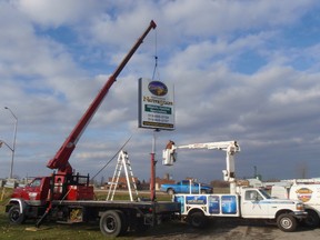submitted photo
A new sign goes into place at Ontario NativeScape, a wildlife habitat specialists company at their office on Baseline Road.