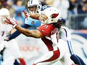 Tennessee Titans cornerback Cody Sensabaugh (24) breaks up a pass intended for Arizona Cardinals wide receiver Larry Fitzgerald (11) during the first half at LP Field. (Don McPeak-USA TODAY Sports)
