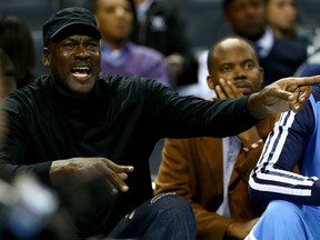 Michael Jordan, owner of the Charlotte Bobcats, yells at a referee after a call during their game against the Brooklyn Nets at Time Warner Cable Arena on November 20, 2013 in Charlotte, N.C. (Streeter Lecka/Getty Images/AFP)
