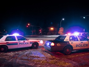 Edmonton Police Service officers investigate after a collision involving at least one pickup truck on 132A Avenue at Victoria Trail in Edmonton, Alta., on Sunday, Dec. 15, 2013. (Ian Kucerak/Edmonton Sun)