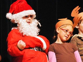 Santa Olen Hopf (left) and Rudolph Kaelyn Burnett were just two of approximately 140 students from the seven kindergarten classes at Upper Thames Elementary School (UTES) to perform during their Christmas concert earlier this month at the jam-packed UTES gymnasium. Other concerts in the region were held last week, and also this week, as we approach the big day! ANDY BADER/MITCHELL ADVOCATE