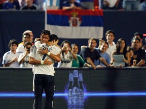 Real Madrid's Cristiano Ronaldo (left) hugs a fan who entered the pitch during regulation time against Chelsea in their International Champions final match in Miami Gardens, Fla., on Aug. 7, 2013. (Andrew Innerarity/Reuters/Files)