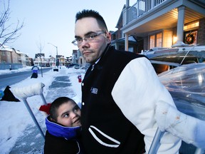 Christopher Garcia-Jones and son Anthony, who has Down syndrome, are wishing for a Good Samaritan to return a gift meant for Anthony that was jettisoned from their van after a chunk of ice smashed through their rear window on Saturday, Dec. 14, 2013. (Stan Behal/Toronto Sun)