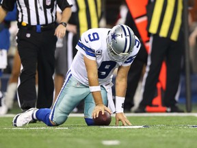 Dallas Cowboys quarterback Tony Romo (9) reacts after getting sacked in the fourth quarter during NFL action against the Green Bay Packers at AT&T Stadium. (Matthew Emmons/USA TODAY Sports)