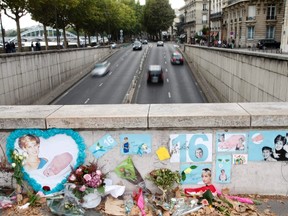 Cars pass through the tunnel overpass where flowers and tributes for the late Diana, Princess of Wales, are seen near the Pont de l'Alma on the 16th anniversary of her death, in Paris August 31, 2013.   REUTERS/John Schults
