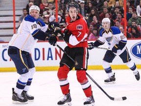 Ottawa Senators' Kyle Turris gets tangled up with St. Louis Blues' Jay Bouwmeester as Kevin Shattenkirk follows the play during NHL hockey action at the Canadian Tire Centre in Ottawa, Ontario on Monday December 16, 2013. Errol McGihon/Ottawa Sun