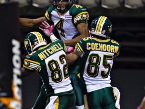Carlton Mitchell celebrates an Adarius Bowman touchdown with Nate Coehoorn during a game at BC Place, one of his two games with the Eskimos last season. (Reuters)