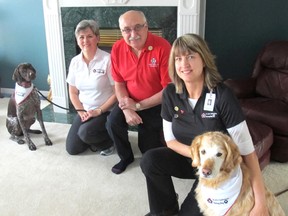 Terry Power, left, with her dog Tess, Phil Szalith, and Jenny Hauser of the St. John Ambulance Therapy Dog program are firm believers in the benefits of dogs on the health of people.