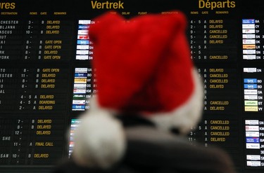 3. Fly on the holiday: A passenger looks at a departure board at Zaventem International airport near Brussels December 24, 2010. (REUTERS/Thierry Roge)