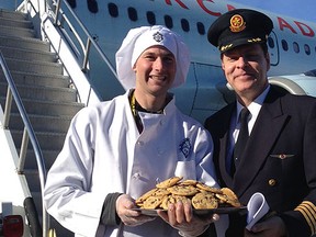 Air Canada Captain Jim Florence and a cookie chef from the Beaver Creek resort in Vail, Colo.,  greet guests arriving for the airline's new flight to the ski area. LORI KNOWLES PHOTO