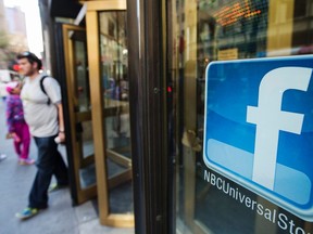 A Facebook logo is attached to the windows of the NBC store inside of Rockefeller Center in New York April 30, 2013. REUTERS/Lucas Jackson