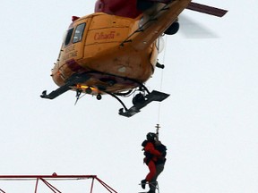 Crews in a helicopter from 8 Wing Trenton rescue a crane operator during a massive fire of a construction site for student housing on Princess and Victoria Streets  in downtown Kingston on Tuesday Dec. 17, 2013. FILE PHOTO BY: IAN MACALPINE/KINGSTON WHIG-STANDARD/QMI AGENCY