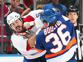 Montreal enforcer George Parros battles the Islanders' Eric Boulton in a game on Saturday night. Parros suffered his second fight-related concussion of the season. (Getty Images/AFP)