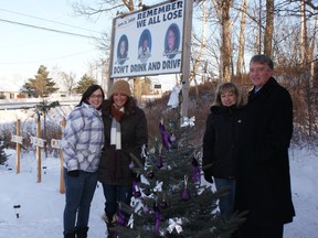 Melissa Philippe (left); Corrie Lamoureux and Lisa Jelley received a donation of three blue spruce trees from Gerry Lougheed for the MPACT 6/21 Foundation memorial. On Sunday; the three families; along with Lougheed; decorated and prepared the tree for the Christmas season. Supplied photo