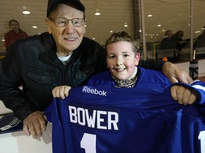Leafs legend Johnny Bower presents Thomas West, 9, with a jersey Tuesday, Dec. 17, 2013. (Dave Thomas/Toronto Sun)