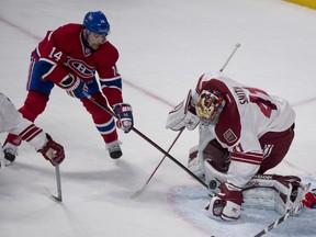 Coyotes goalie Mike Smith makes a save Canadiens forward Tomas Plekanec looks for a rebound during second period action in Montreal on Tuesday, Dec. 17, 2013. (Pierre-Paul Poulin/QMI Agency)