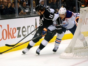 Anze Kopitar powers past Oilers defenceman Andrew Ference behind the Oilers net Tuesday at the Staples Center in Los Angeles. (USA TODAY)