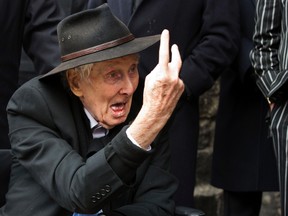 File photograph shows Great Train Robber Ronnie Biggs gesturing as he arrives for the funeral of Bruce Reynolds, at the church of St. Bartholomew the Great in London on March 20, 2013. (REUTERS/Neil Hall/Files)
