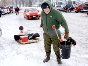 Adrion Kaster, of Kent Bridge, joined dozens of ice fishers at Mitchell's Bay at the crack of dawn Wednesday to try his luck at landing a pail of freshly-caught perch and other pan fish taking bait this week. Kaster is getting a jump on the 2013-14 season thanks to colder-than-normal December temperatures. The popular sport is enjoying it's earliest start to the season in recent years on Mitchell's Bay and Lake St. Clair. (BOB BOUGHNER, The Daily News)